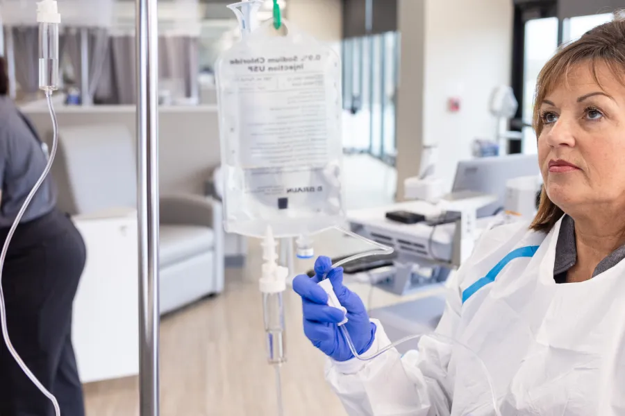 Amy McGargill, RN, BSN, and MacKenzie VanDenBerg, RN BSN, with a patient at Mission Cancer + Blood - Waukee, part of UI Health Care, on Thursday, April 2, 2026. Patient consent on file; image may be altered to remove private information.