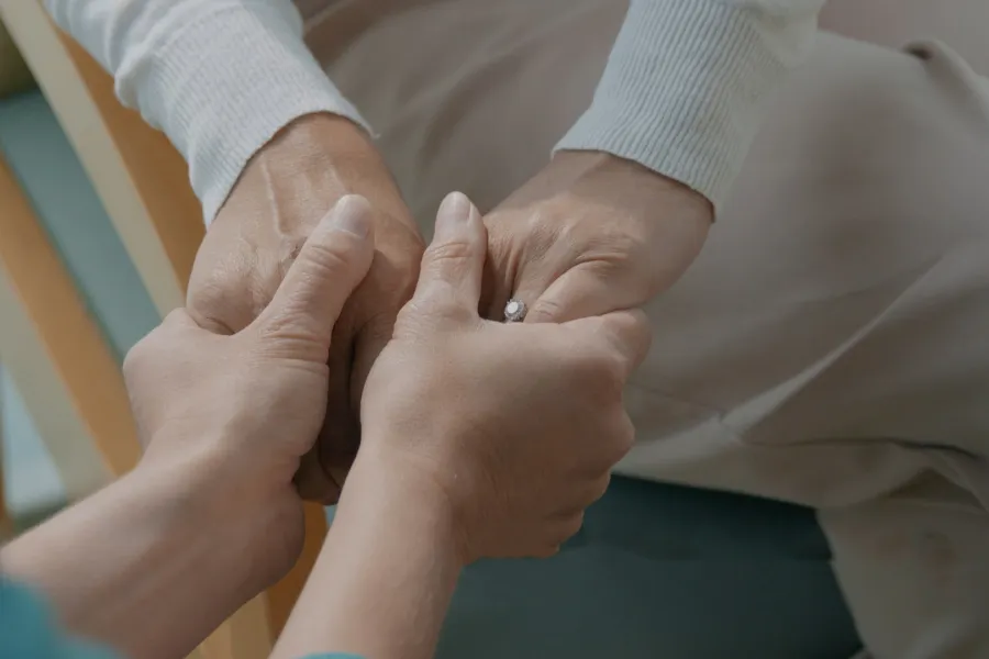 Image of two people holding hands
