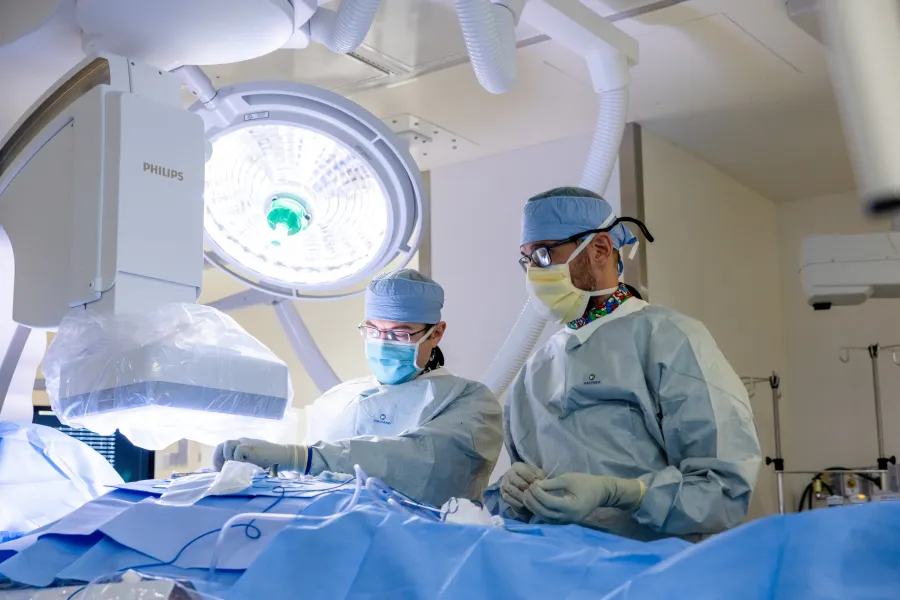 Paari Dominic, MBBS, MPH, with fellow Brett Johnson. Cardiac electrophysiology in the Cath lab at UI Health Care Medical Center University on Monday, Feb. 16, 2026. 
