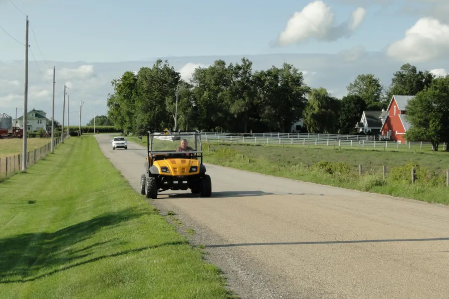 An ATV driving on a road.