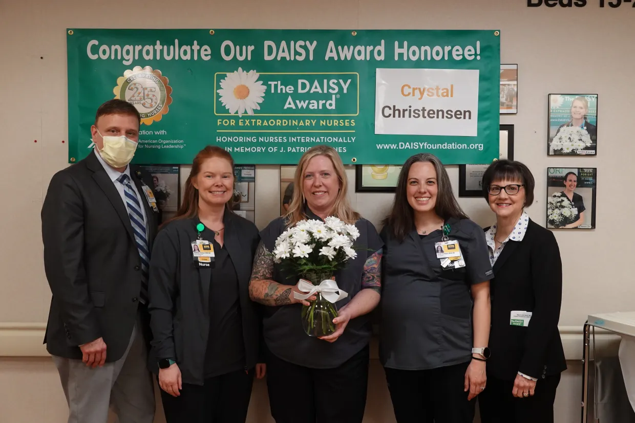 Crystal Christensen (center) BSN, RN, CCRN, celebrates her DAISY Award with other members of the nursing team.