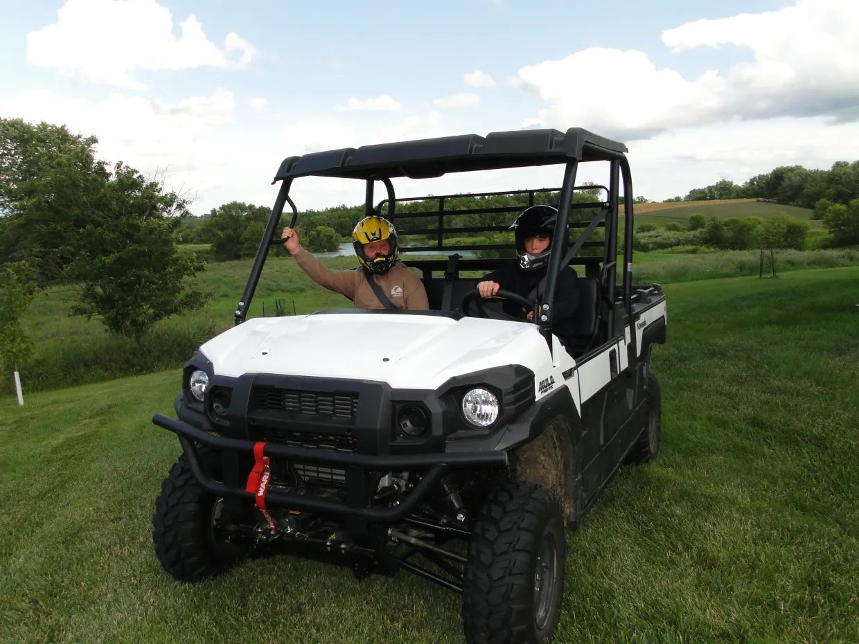 two children sitting inside an ATV