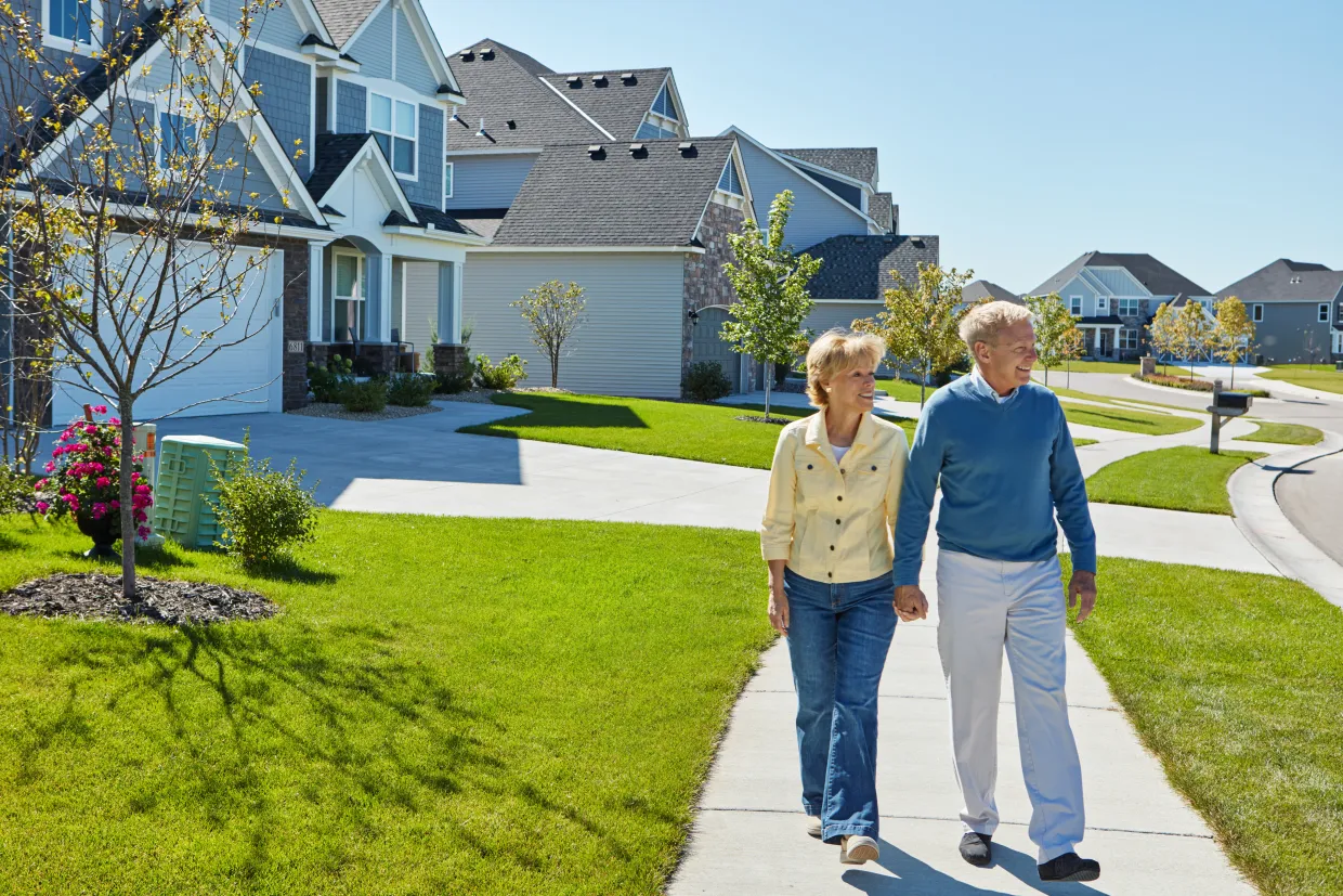 Holding hands, walking and elderly couple in neighborhood for fresh air, wellness and active in morning. Retirement, marriage and happy senior man and woman on sidewalk for bonding, love and health