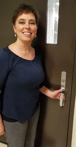Julie Lensing opens a door