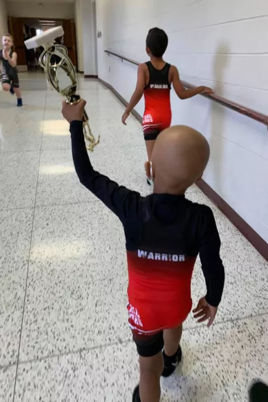 Eli shows off his wrestling trophy