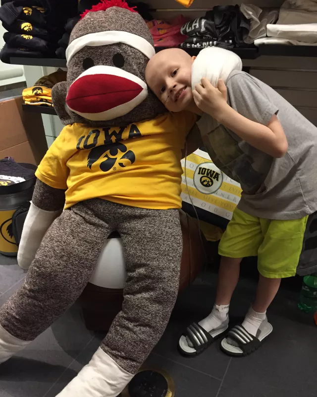 Cormac Faley enjoys some fun with Volunteers Services sock monkey