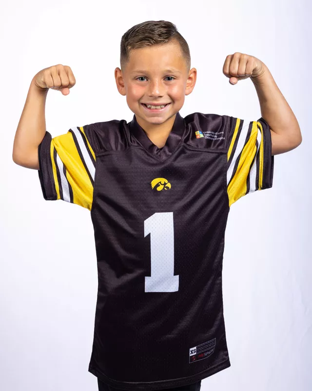 Tate Manahl flexing his muscles during a photo shoot.