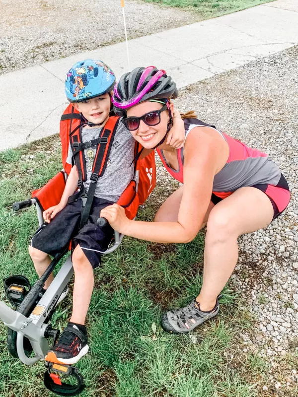 Carver Meines and his mother as he rides a bike