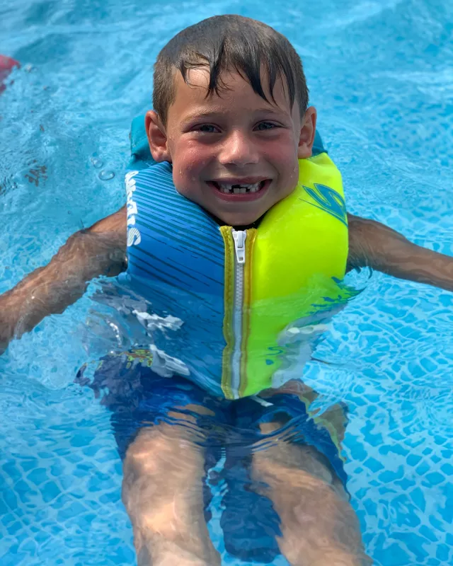 Tate Manahl swimming in the pool.