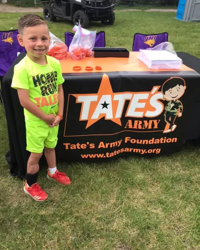 Tate Manahl at a TATESARMY.ORG booth for lawn mower safety
