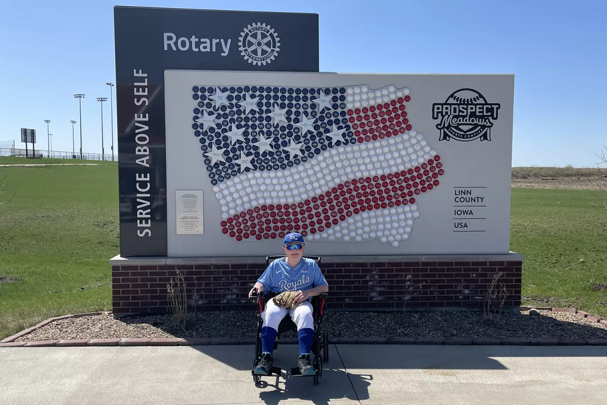 Dylan McGivern in front of a baseball monument