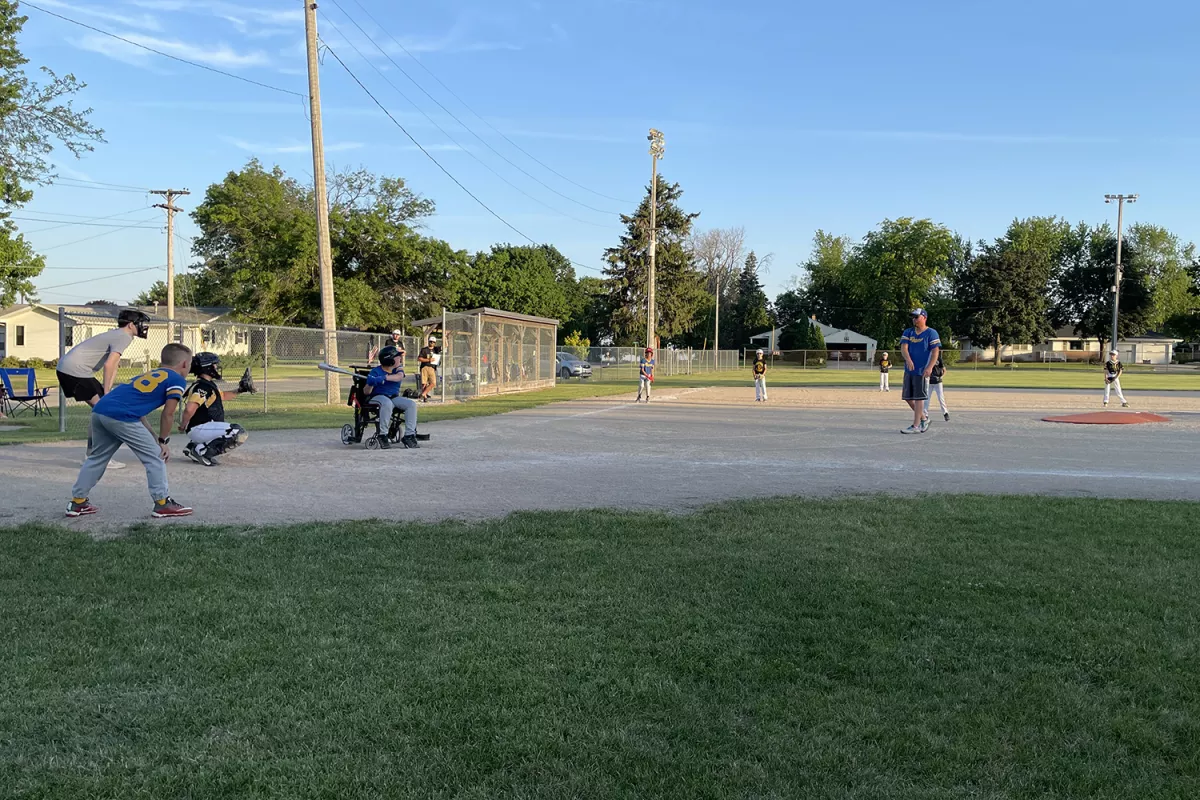 Dylan McGivern at bat in his wheelchair