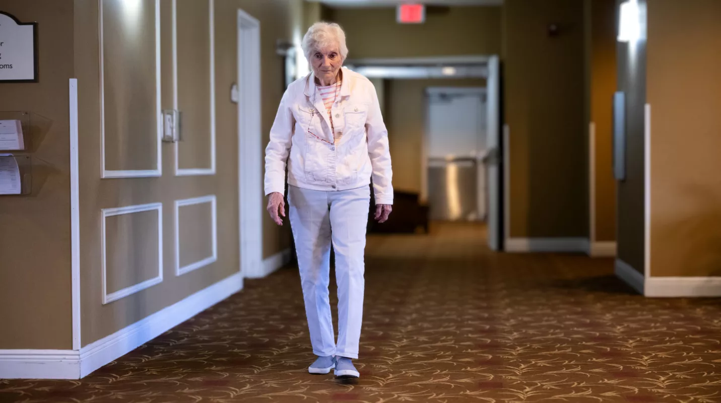 Margaret Coleman walking down the hallway