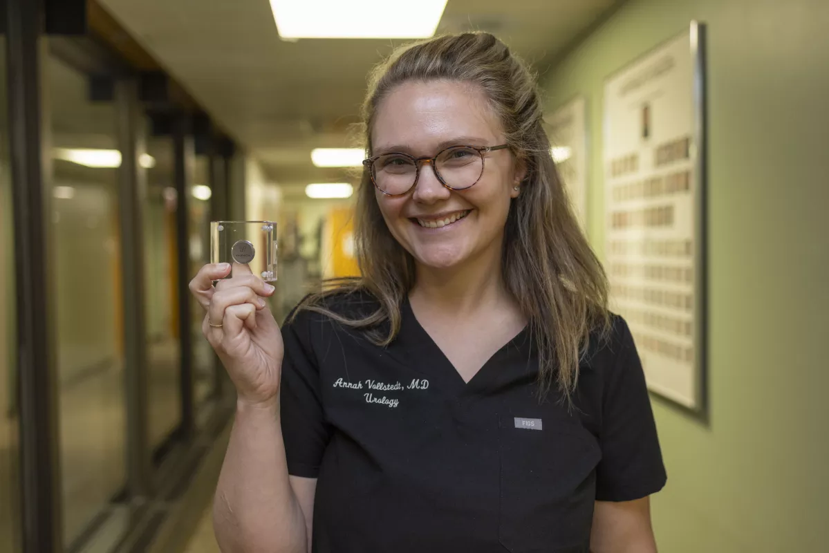 Dr. Annah Vollstedt holds the eCoin Peripheral Neurostimulator