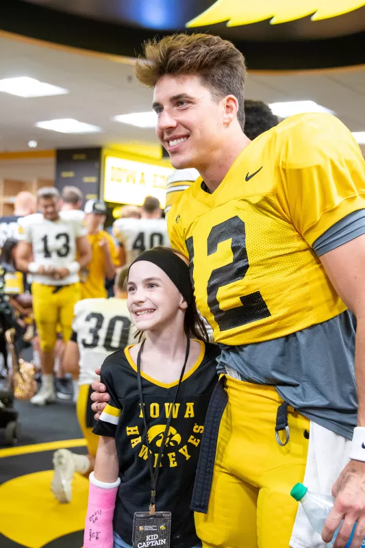 Gracelyn meets an Iowa football player on Kids Day