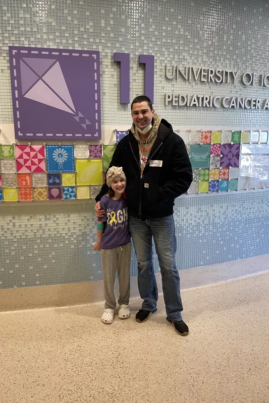 Gracelyn and her father Marty stand on the 11th floor of UI Stead Family Children's Hospital