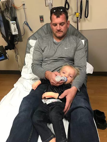 Nile Kron held by his father during an ER visit