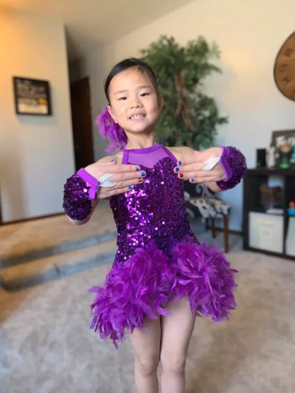 Kid Captain Chloe Dinkla in a purple dancing outfit