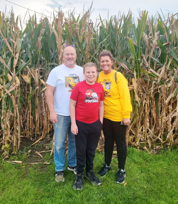 Kid Captain Cooper Estenson and parents at the Field of Dreams