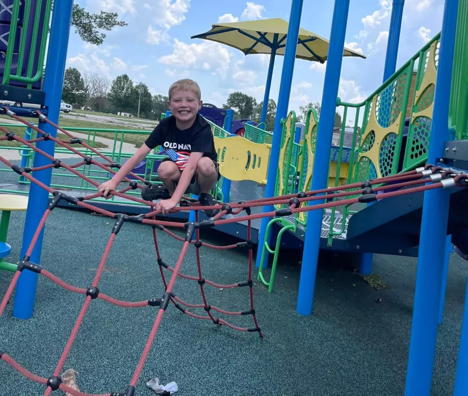 Kid Captain Aiden Washburn on playground equipment