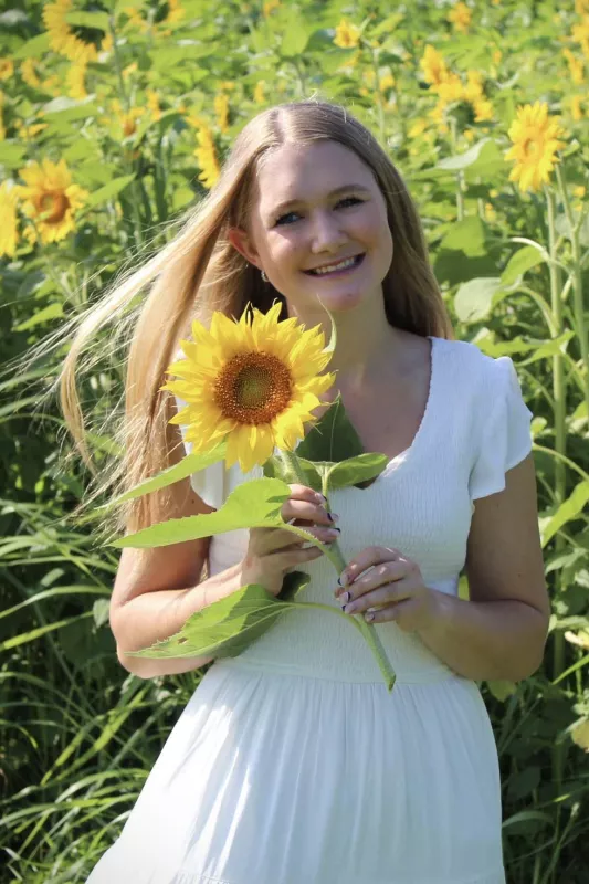 May Gilchrist in a field of sunflowers