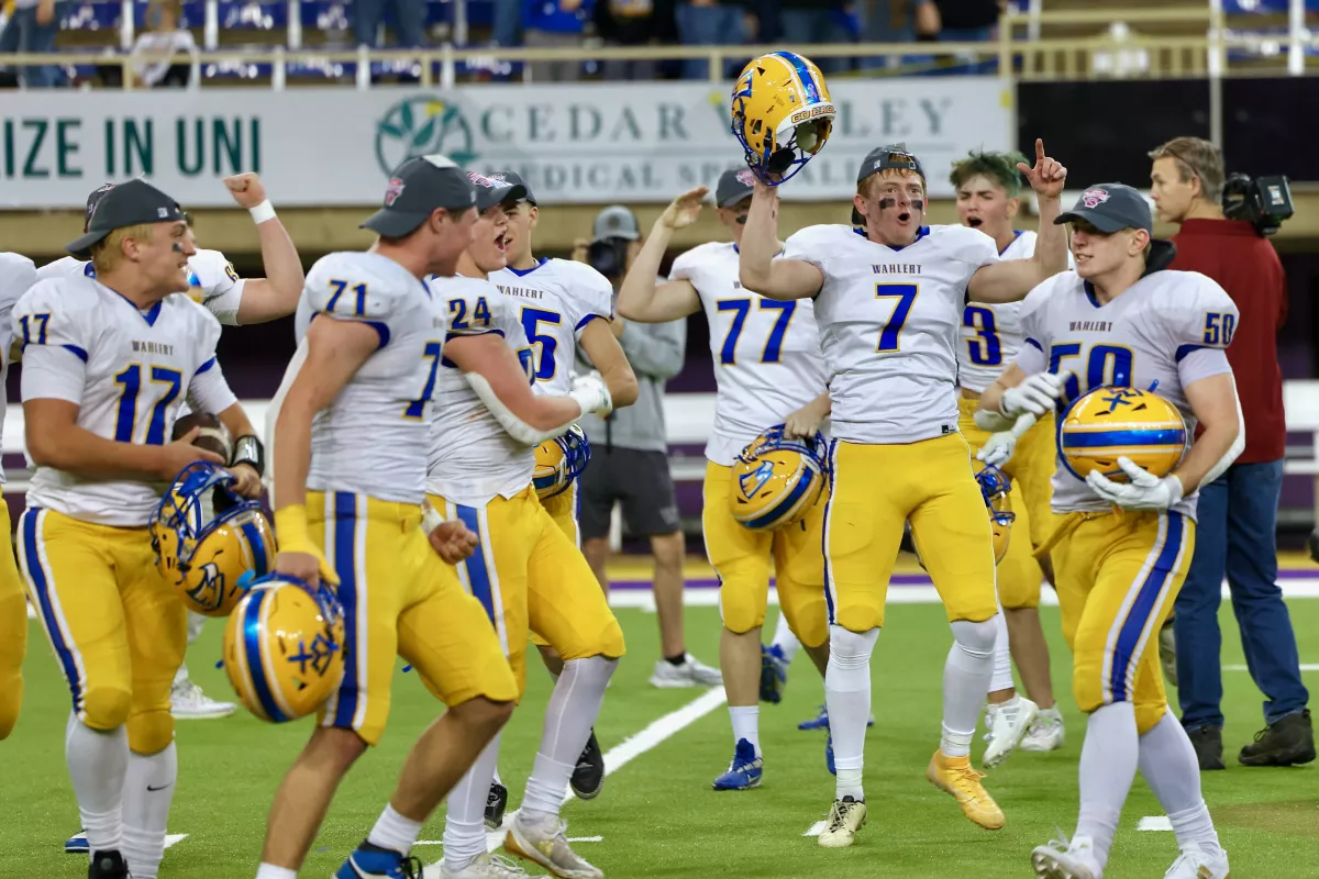 High school senior Nathan Schiesl celebrating with his football teammates during a game