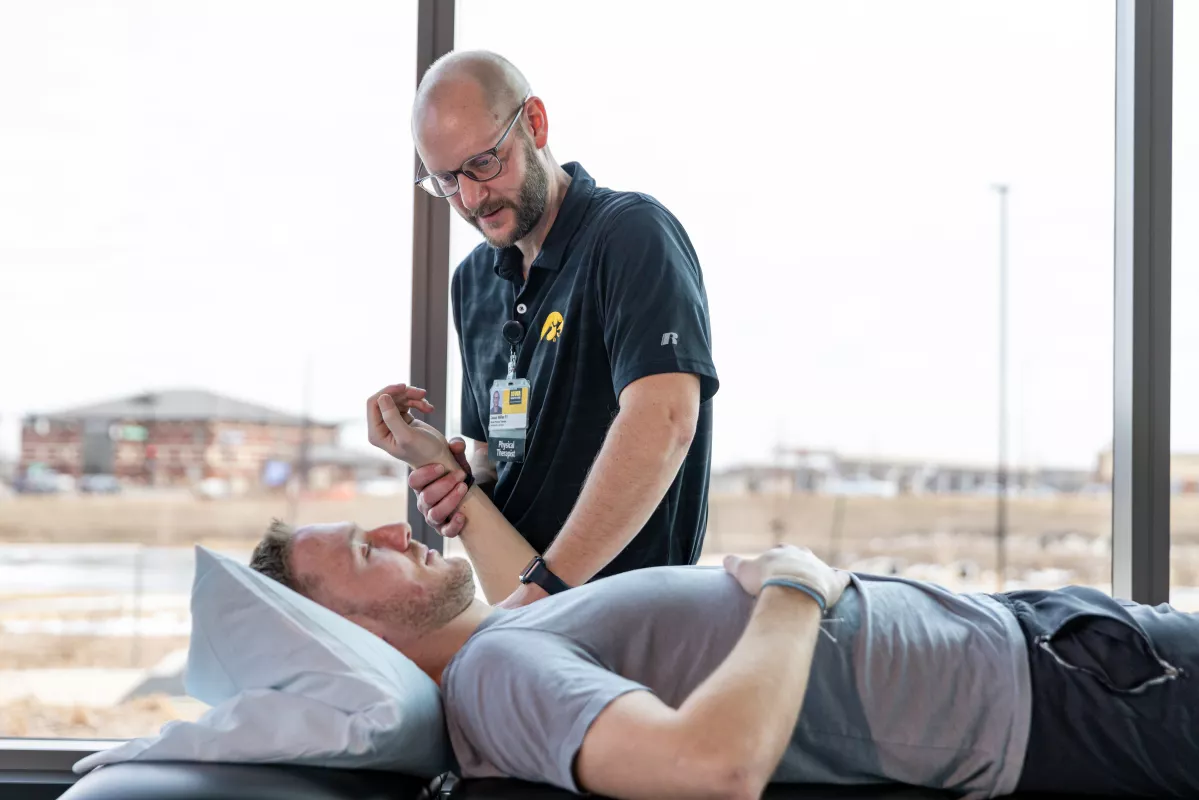 physical therapist Jason Willer, PT MPT, with a simulated patient in the physical therapy gym at UI Health Care Medical Center North Liberty on Monday, Feb. 24, 2025.