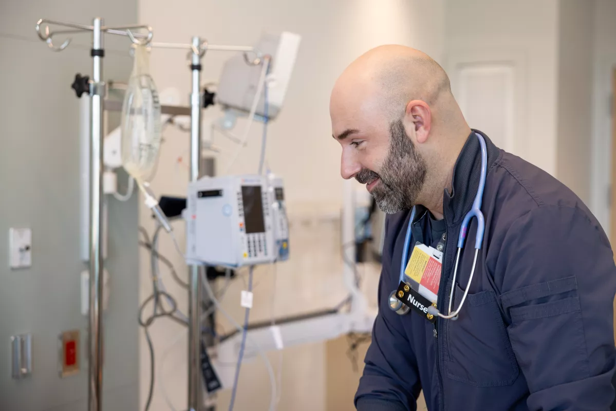 Assistant nurse manager Alex Thomalla, RN BSN, with simulated adult inpatient at UI Health Care Medical Center North Liberty on Friday, Feb. 28, 2025.