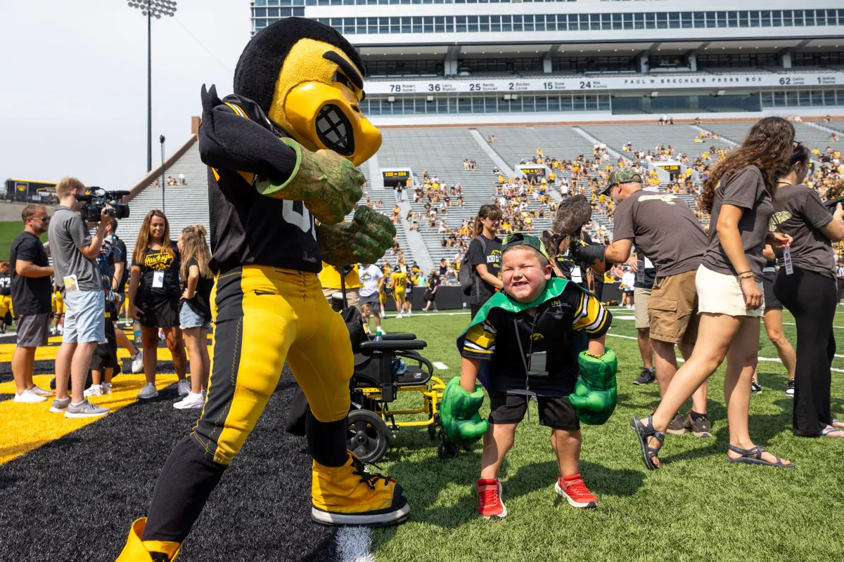 Kid Captain Micah Norby and Herky "Hulk out" during the festivities on the field.