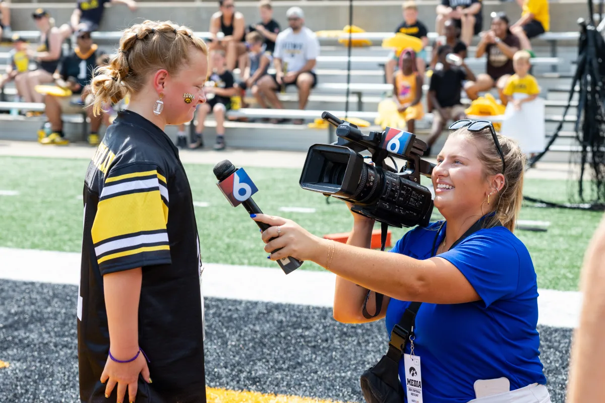 Kid Captain Harper Atkinson enjoys a moment in the spotlight when she's interviewed on the field during Kids' Day.
