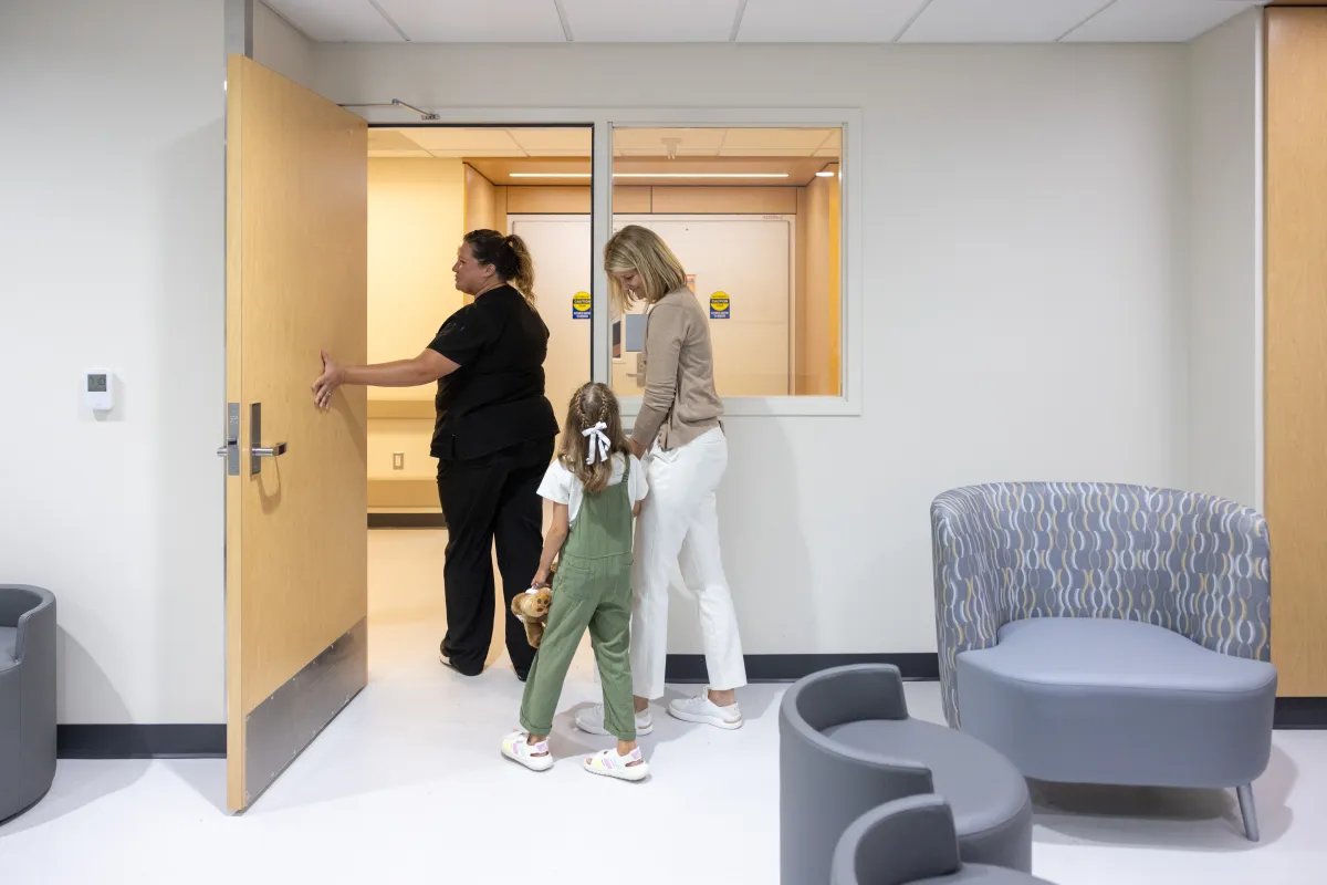 Staff nurse Sydne Oszfolk, RN BSN, greets a simulated pediatric patient in the dedicated pediatric waiting room at UI Health Care Pediatric Emergency Department at the university medical center on Wednesday, Aug. 13, 2025. Simulated patients with consent forms on file.