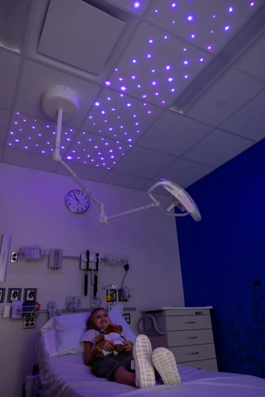 Simulated patient in a procedure room with colorful lights in the UI Health Care Pediatric Emergency Department at the university medical center on Wednesday, Aug. 13, 2025. Simulated patients with consent forms on file. 