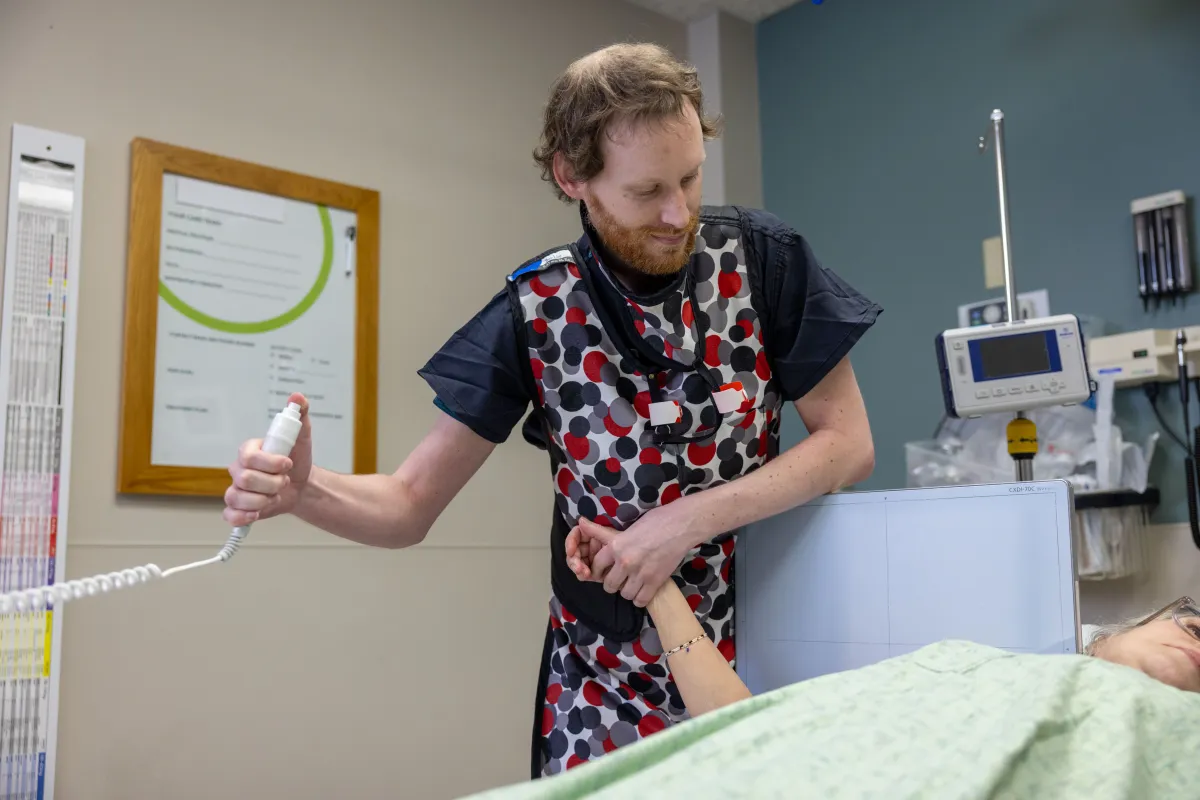 Radiology technologist with mobile x-ray and simulated patient in the emergency department at the University of Iowa Health Care Medical Center Downtown on Tuesday, April 2, 2