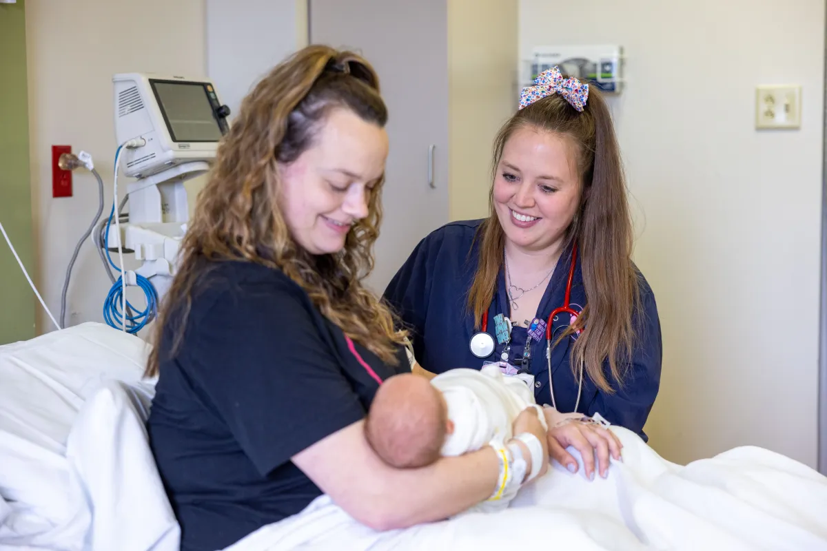 Newborn infant and mother with nurse Stephanie Timm in the maternal child unit at University of Iowa Health Care Medical Center Downtown on Thursday, April 11, 2024. Patient consents on file.