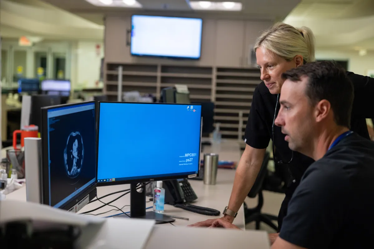 Emergency medicine physician Timothy Witalka, MD, and physician assistant Allison Walsh, PA-C, at the emergency department at UI Health Care Medical Center Downtown on Friday, June 13, 2025. Portion of screen has been altered.