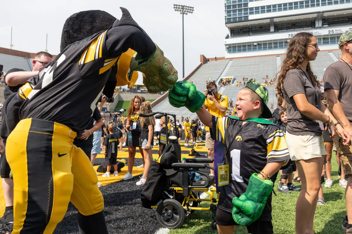 Kid Captain Micah Norby and Herky "Hulk out" during the festivities on the field.