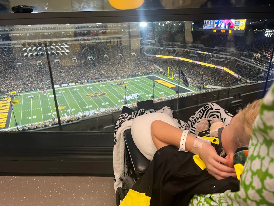 Kid Captain Luke Johnston watching an Iowa Football game
