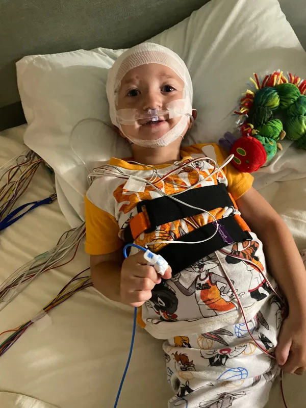 Kid Captain Luke Johnston lying in a hospital bed