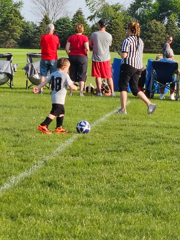 Kid Captain Micah Norby playing soccer