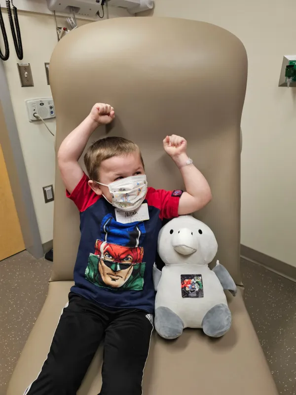Kid Captain Micah Norby sitting in a hospital bed