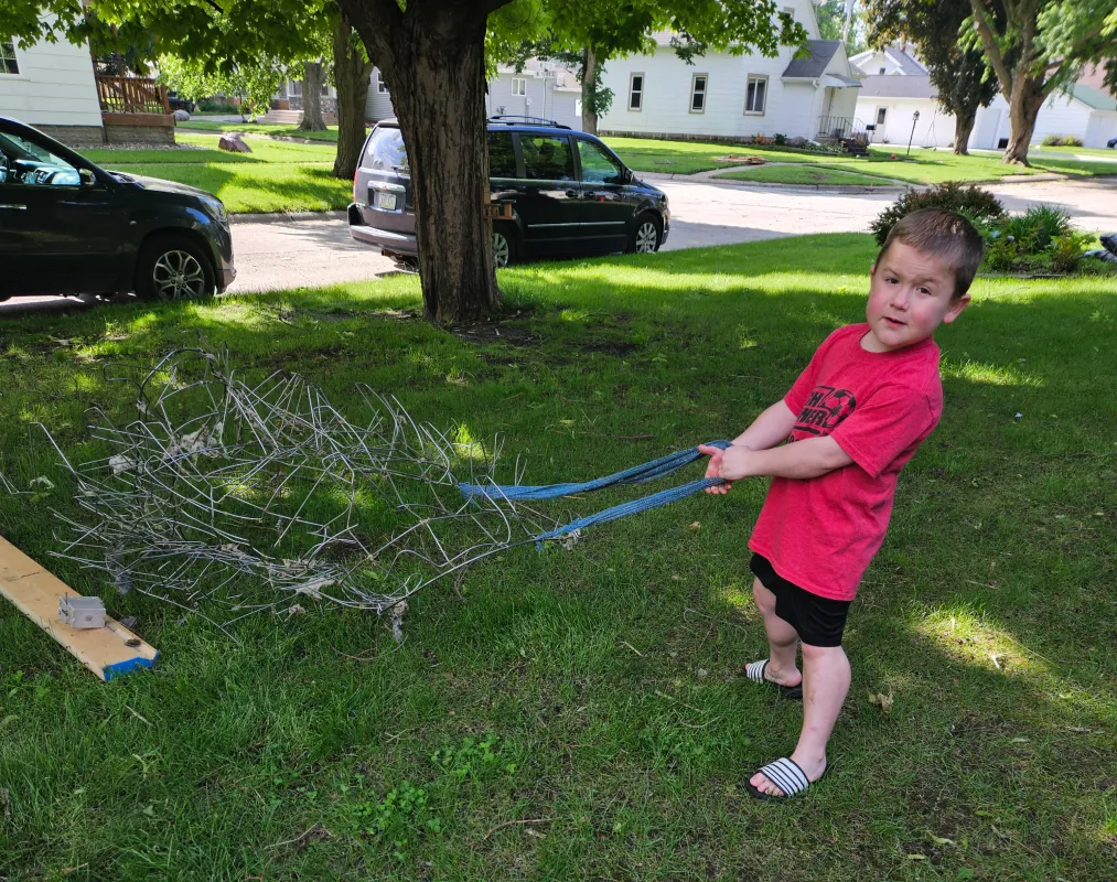 Kid Captain Micah Norby holding a branch