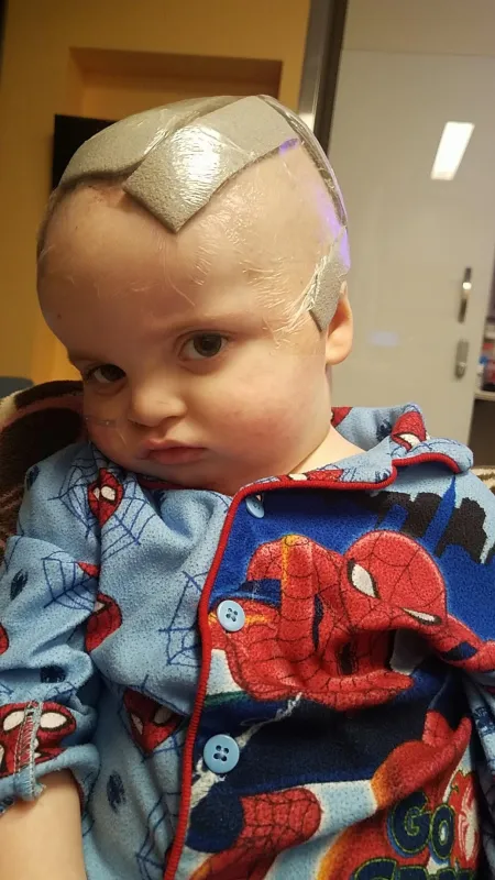 Kid captain Ray Walker as a baby with his head incision mark covered