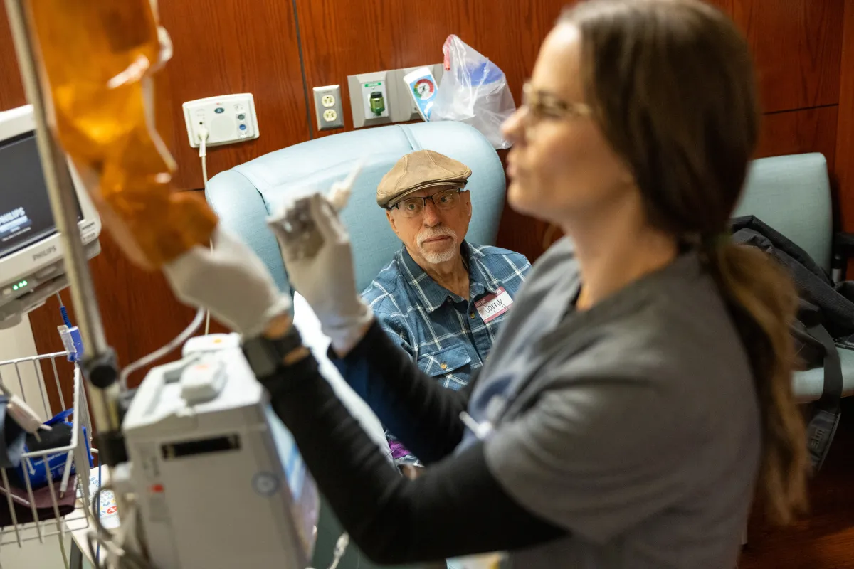 Staff nurse Kiley Eastwood, RN ADN, prepares an infusion of ascorbic acid (Vitamin C) for Garry Buettner at Holden Comprehensive Cancer Center on the UI Health Care university campus on Wednesday, Dec. 3, 2025. 