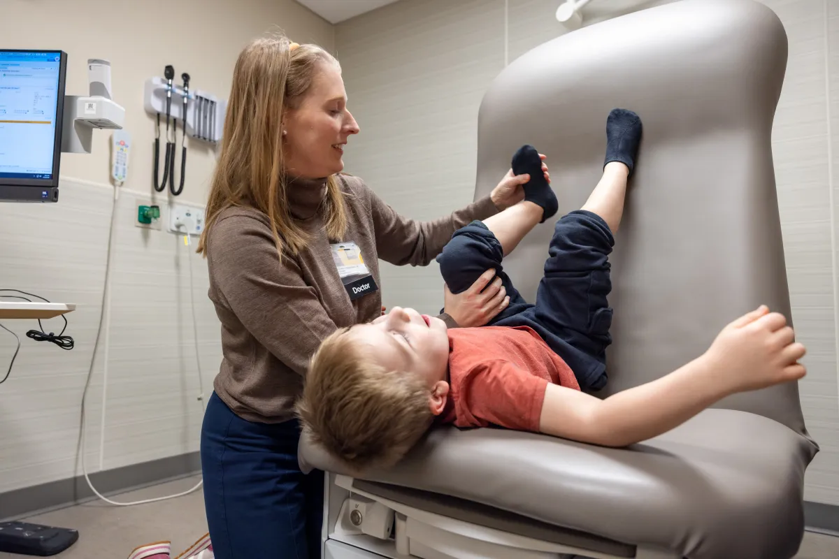 Sawyer Conrad, 5, with care team members neurosurgeon Rebecca Reynolds, MD, and physiatrist Kathleen Vonderhaar, MD, and parents Rachel and Hubert Conrad on Wednesday, March 18, 2026. Sawyer is seen through the multi specialty spasticity clinic for children, and was treated through a selective dorsal rhizotomy (SDR).