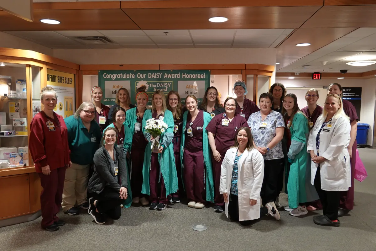 Abby Blietz receives daisy award with her team.