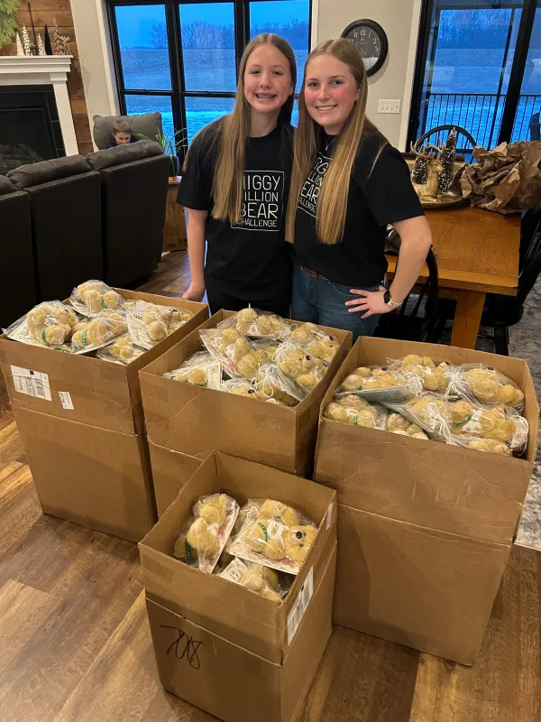 Meredith Secymore and Addy Blade packaging 280 custom teddy bears for patients with scoliosis.