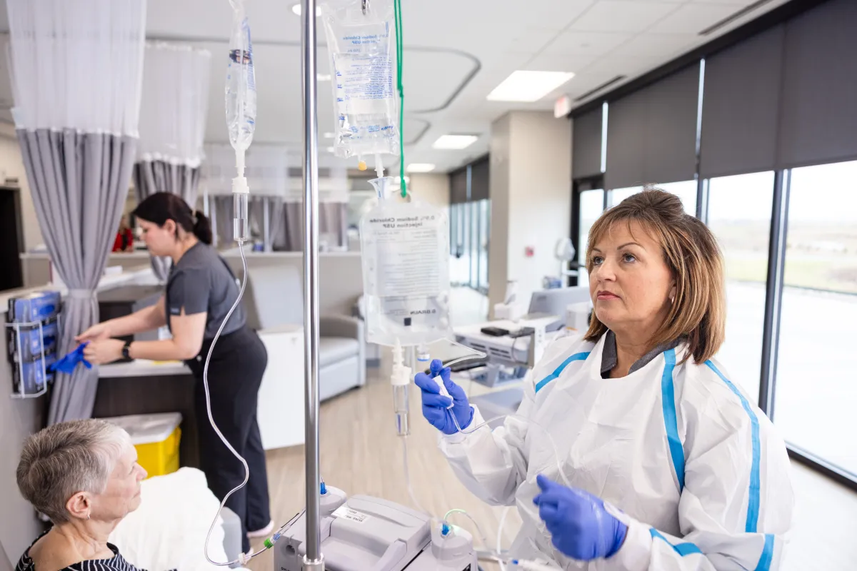 	 Amy McGargill, RN, BSN, and MacKenzie VanDenBerg, RN BSN, with a patient at Mission Cancer + Blood - Waukee, part of UI Health Care, on Thursday, April 2, 2026. Patient consent on file; image may be altered to remove private information.