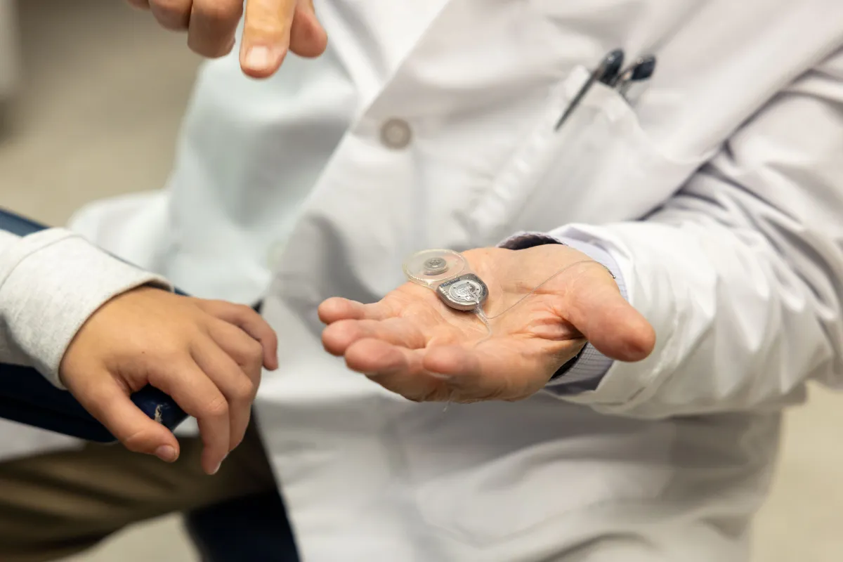 Provider holding Cochlear device