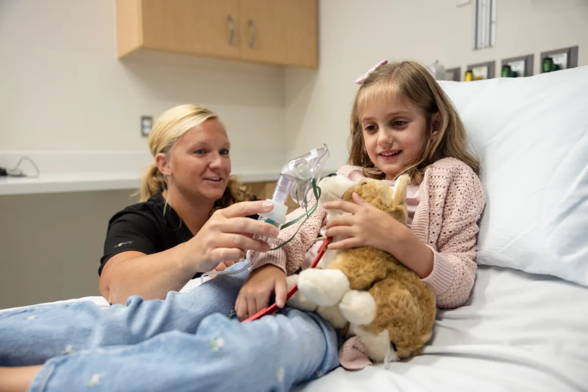 Staff nurse Rachel Ballard, ADN RN, demonstrates a breathing treatment with simulated pediatric patient in an exam room at UI Health Care Pediatric Emergency Department at the university medical center on Wednesday, Aug. 13, 2025. Simulated patients with consent forms on file.