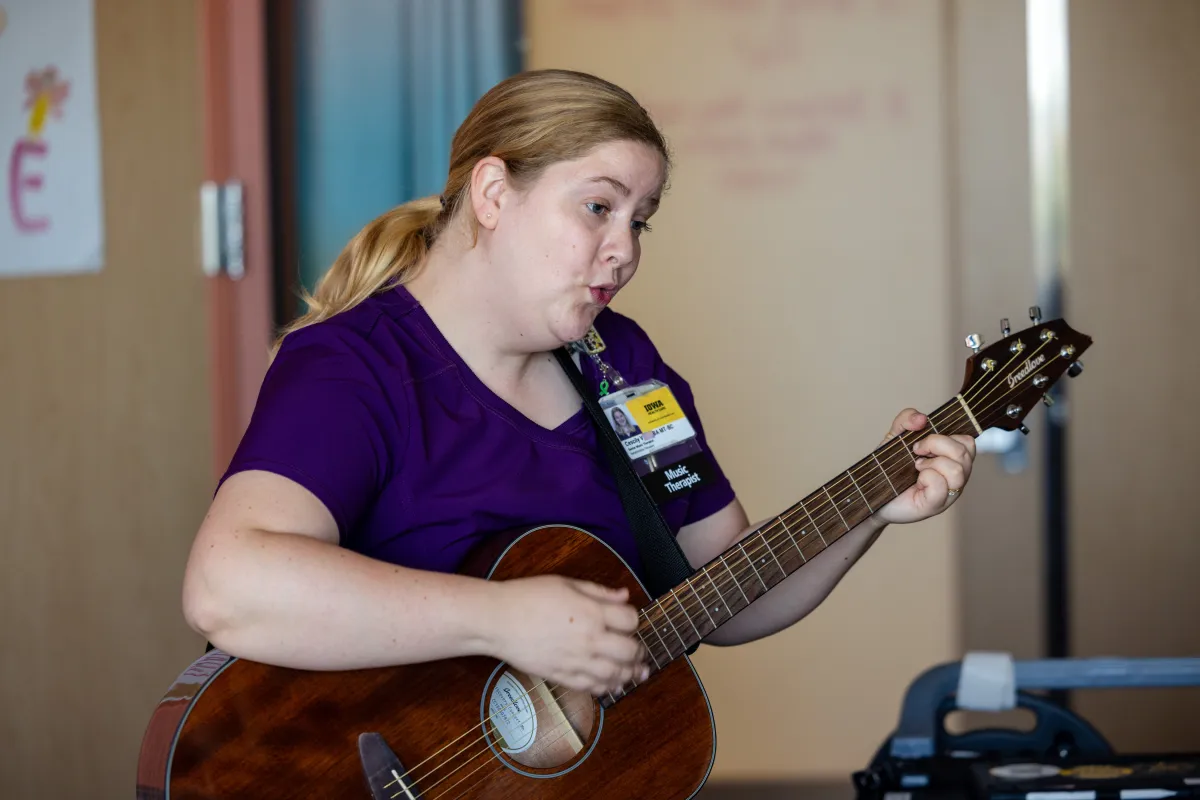 Music Therapist playing guitar